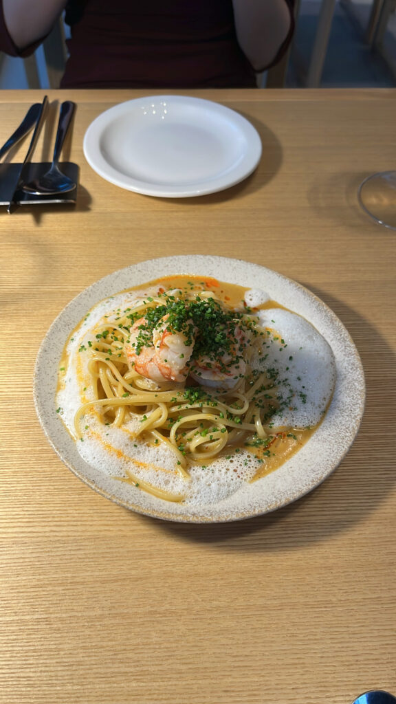 Close-up of exquisitely plated Red Shrimp X.O Pasta garnished with gourmet sauce