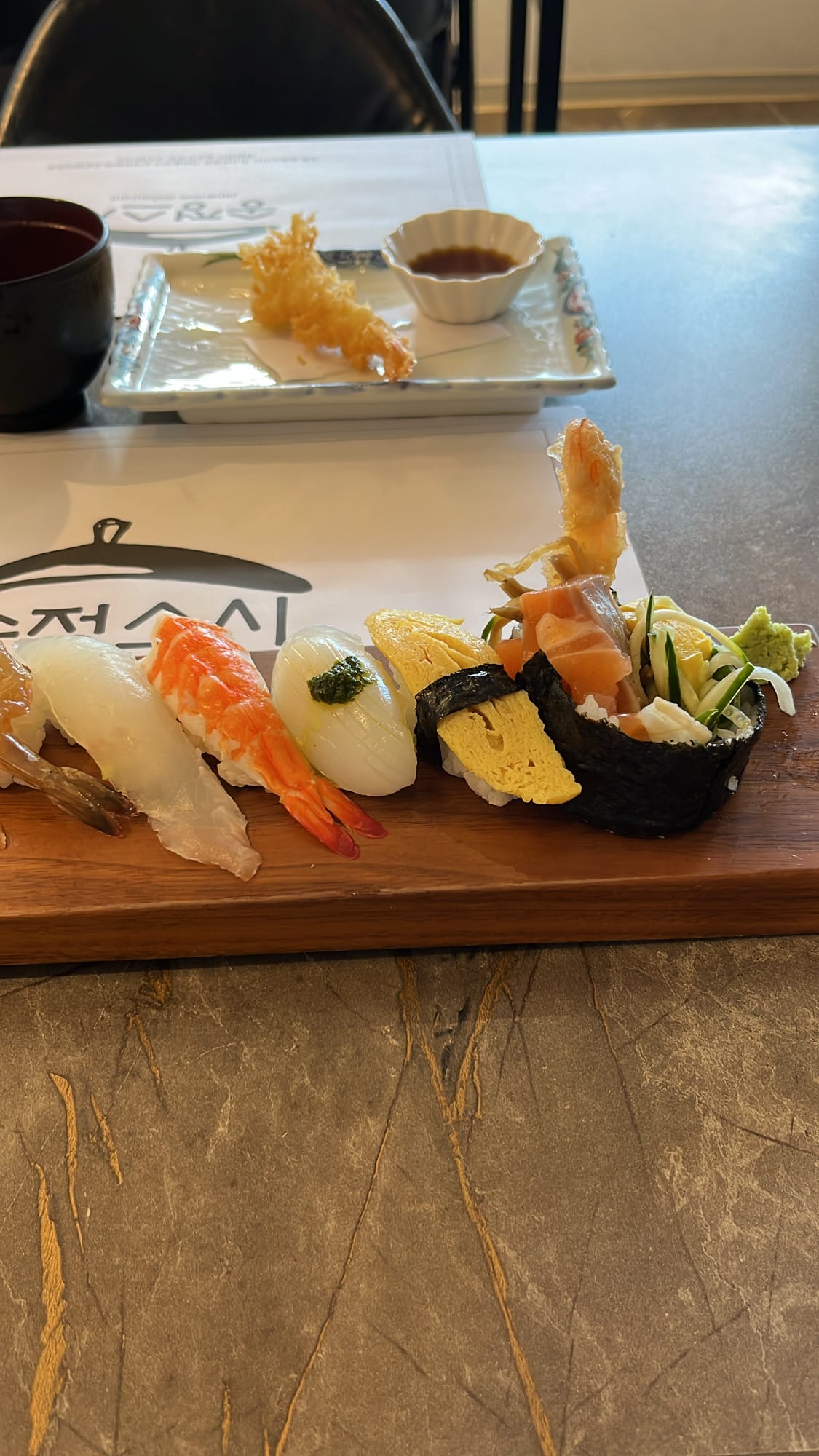 Close-up view of moist, glossy, and remarkably fresh nigiri pieces served at Songjeong Sushi Busan