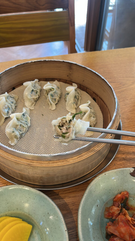 Steamed handmade dumplings served in a bamboo steamer at Songjeongjib