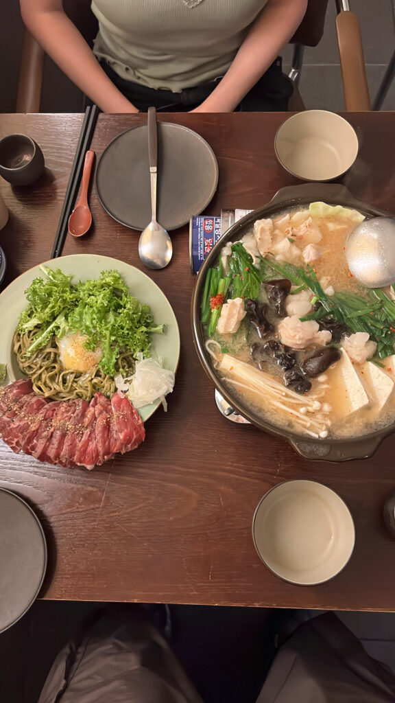 Motsunabe hotpot and basil soba with beef tataki served at Kuchiga Busan