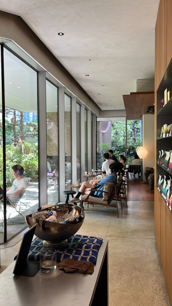 Wide indoor seating layout alongside panoramic glass windows at Momos Coffee Marine City