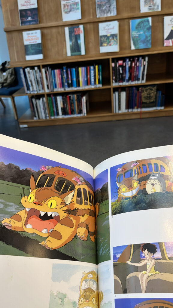 Iconic Catbus animation scene open in the Totoro art book at the library