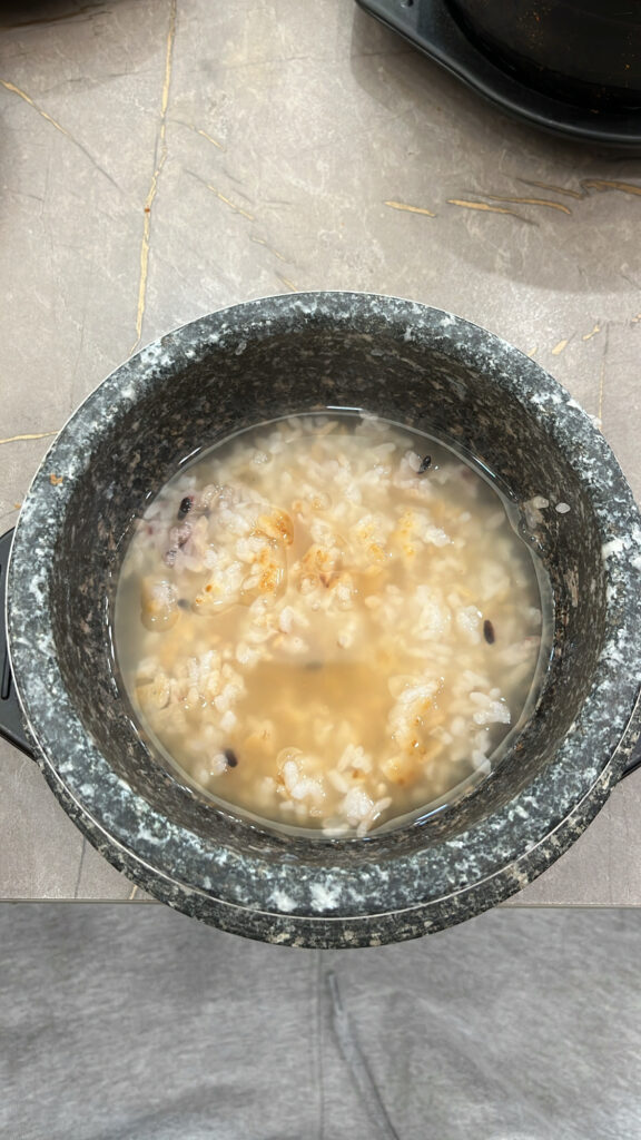 Warm scorched rice soup Nurungji served after spicy soft tofu stew