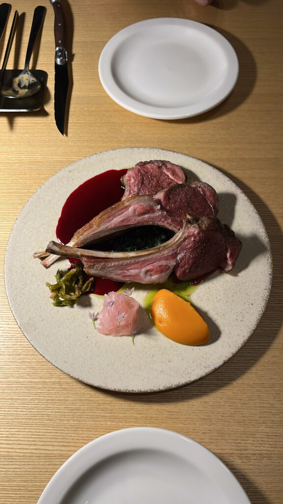 Top-down view of the delicate and savory seasonal lamb steak course at Sobae Busan
