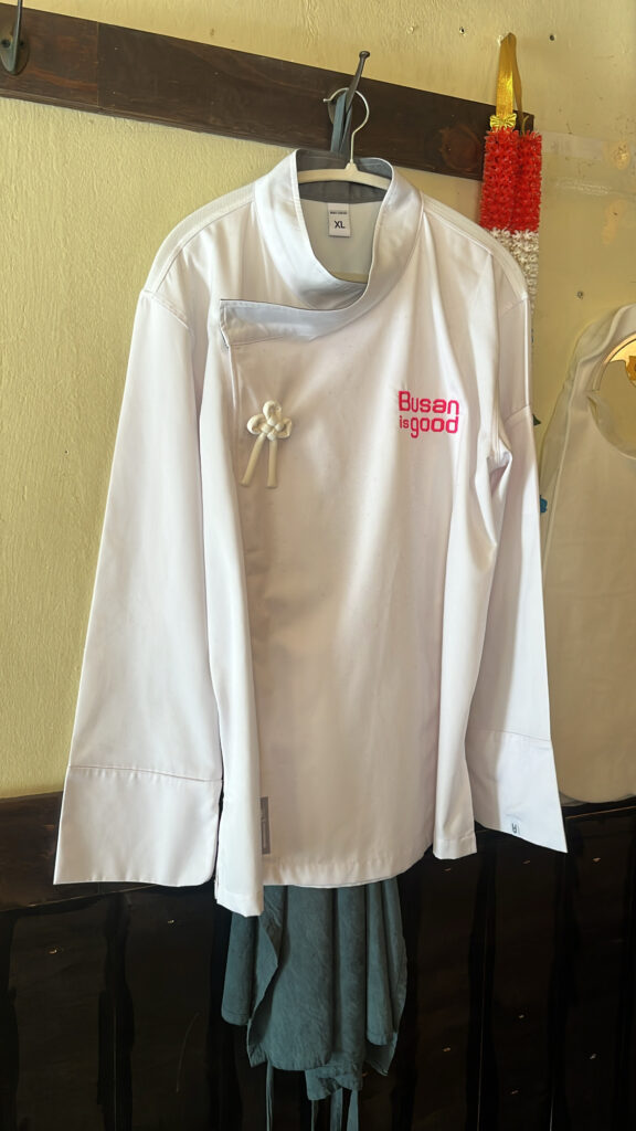 Chef jacket and charming Thai souvenir decorations hanging on the restaurant wall