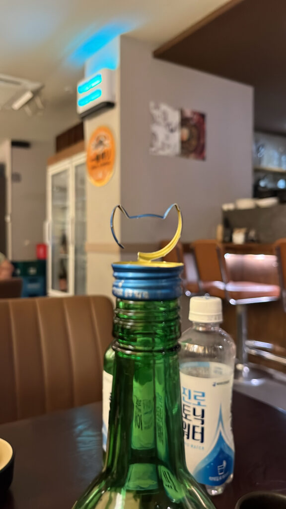 Cute cat bottle cap decor at Kuchiga Gwangalli