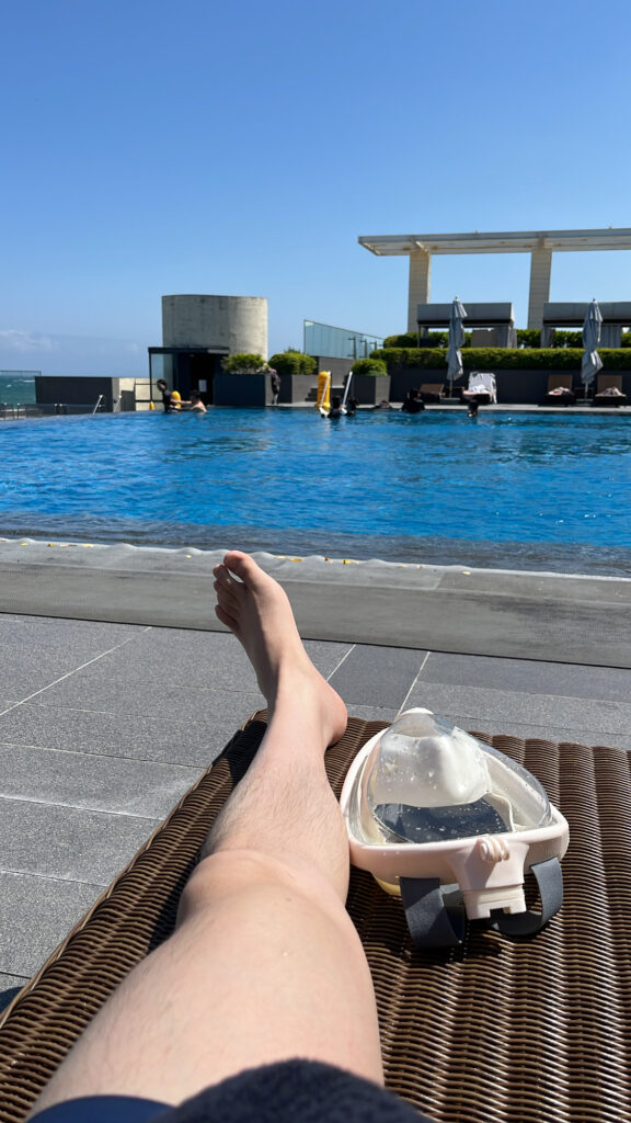 Relaxing on complimentary poolside sunbeds at the outdoor swimming pool