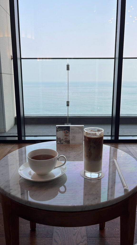 Iced cafe latte and hot Earl Grey tea served by the window at McQueen's Lounge Busan