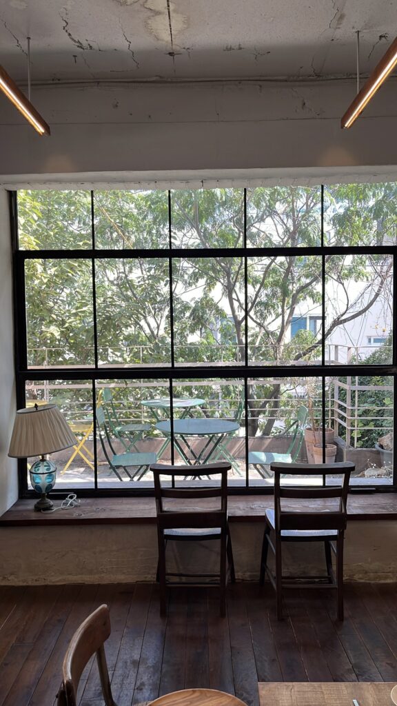 Large window view looking out into the green outdoor garden at Green Nomad Busan
