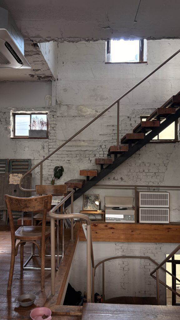 Wooden staircase leading to the 3rd floor inside Green Nomad Busan