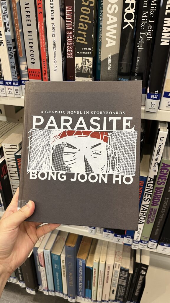 Bong Joon-ho's Parasite screenplay and storyboard book displayed on library shelf