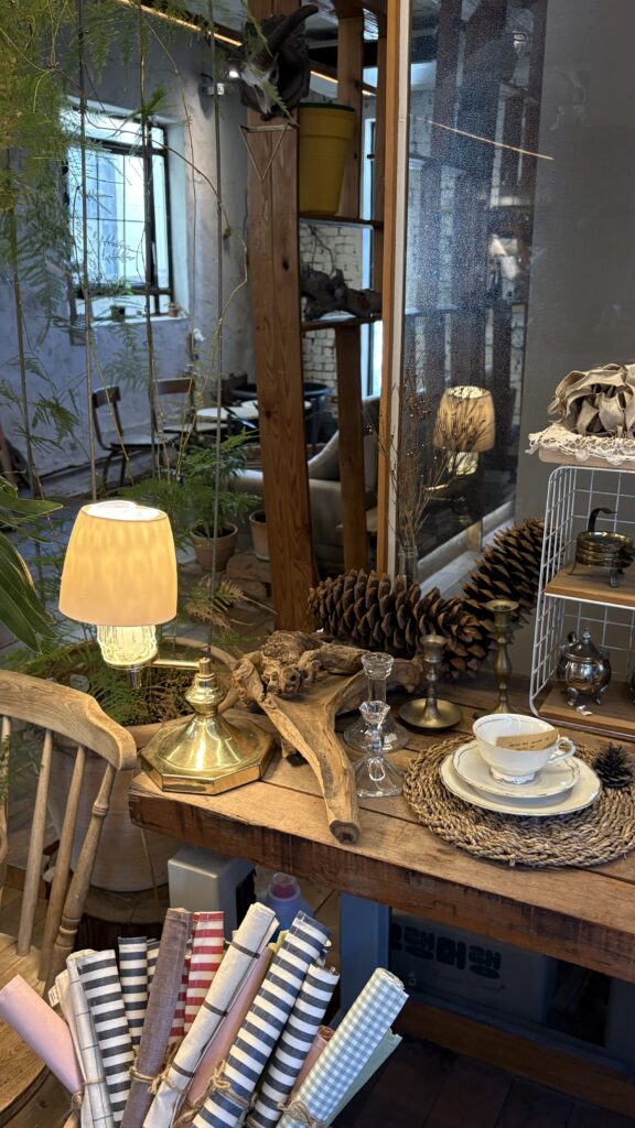Giant pinecone ornament placed on a vintage desk inside Green Nomad Busan