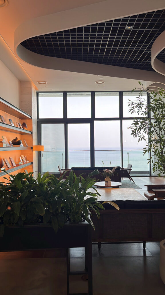 Sophisticated seating space and architectural interior connecting McQueen's Lounge and McQueen's Bar at Ananti at Busan Cove