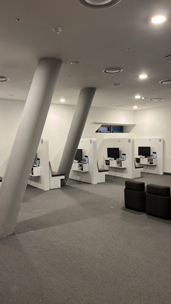 Spacious multimedia room equipped with individual seating booths and TV monitors