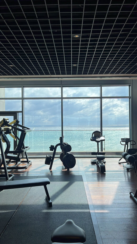 9th-floor fitness center featuring cardio machines and panoramic ocean views