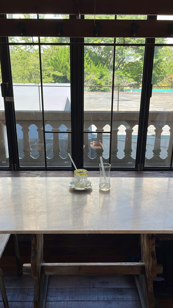 Empty beverage glasses and mugs after enjoying the drinks on a wooden table at Green Nomad Busan