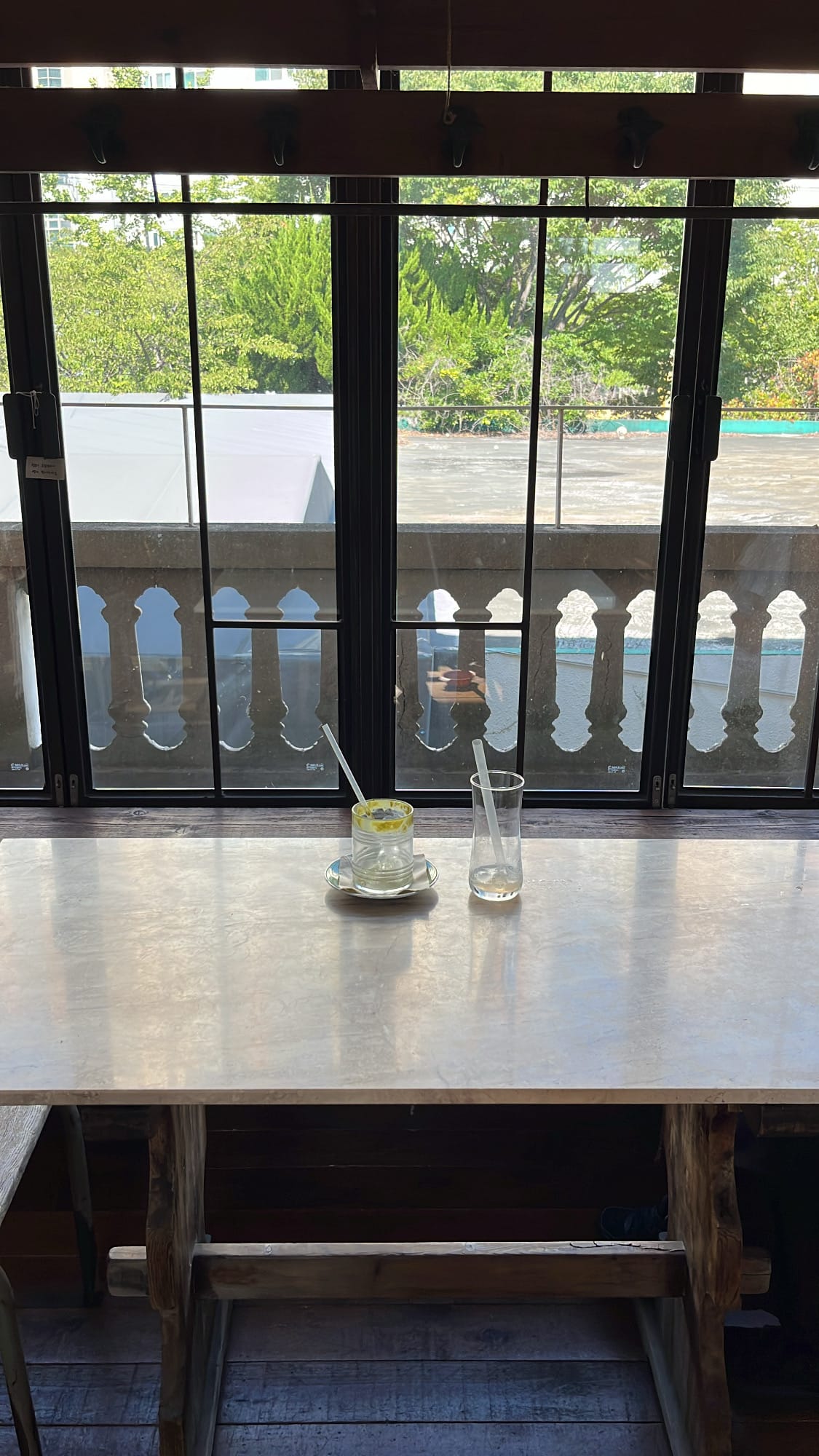 Empty beverage glasses and mugs after enjoying the drinks on a wooden table at Green Nomad Busan