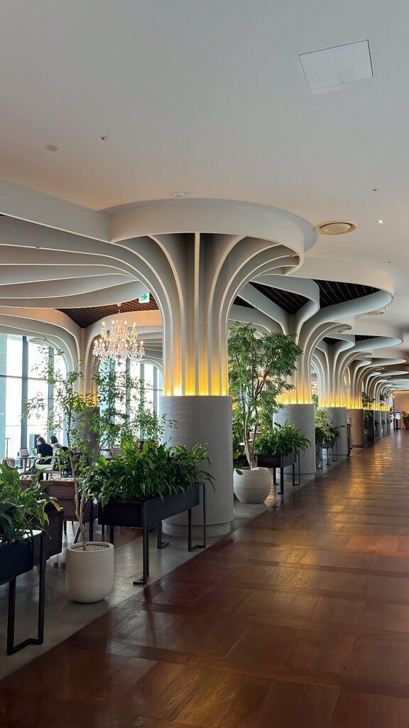 Hallway with high ceilings leading straight to McQueen's Bar and the outdoor terrace seating overlooking the sea.