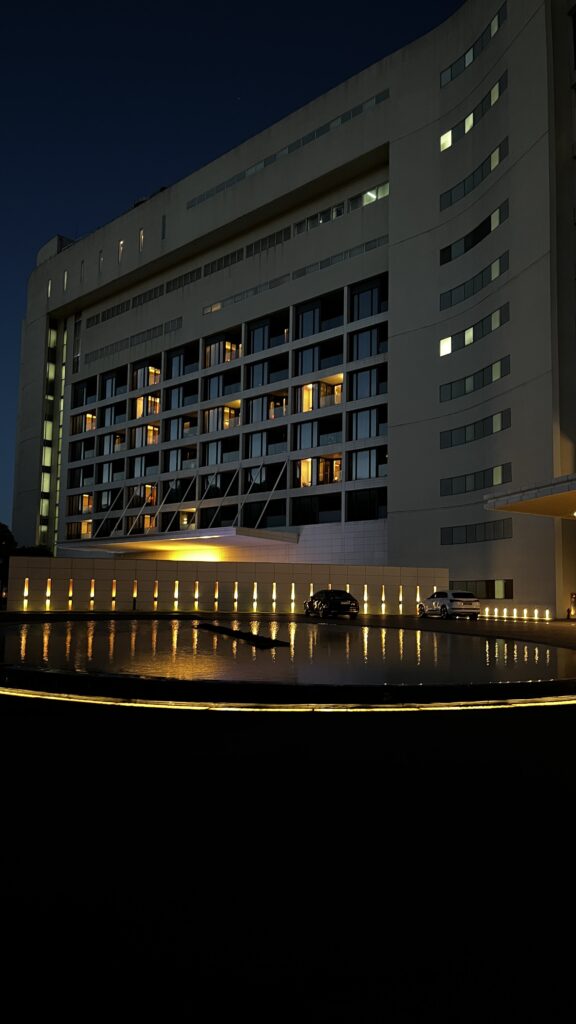 Nighttime illuminated hotel building reflection at Ananti at Busan Cove