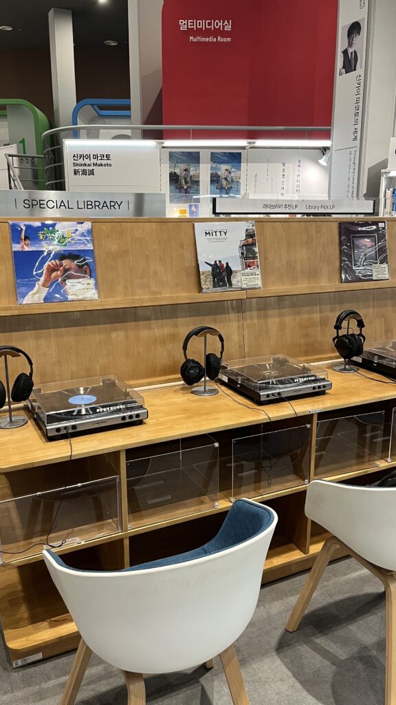 Cozy LP vinyl listening station equipped with turntables and headphones at the library