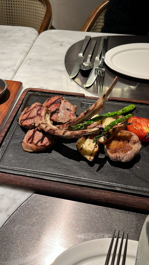 Gourmet grilled dinner dish served at McQUEEN'S Bar on the 10th floor