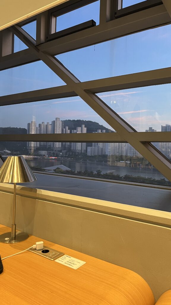 Sunset glow through the glass window seating at Busan Cinema Center Library
