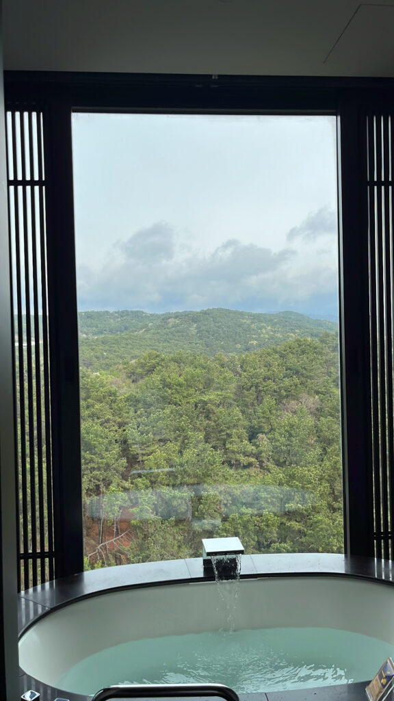Deep soaking bathtub with serene mountain and sea views in the morning
