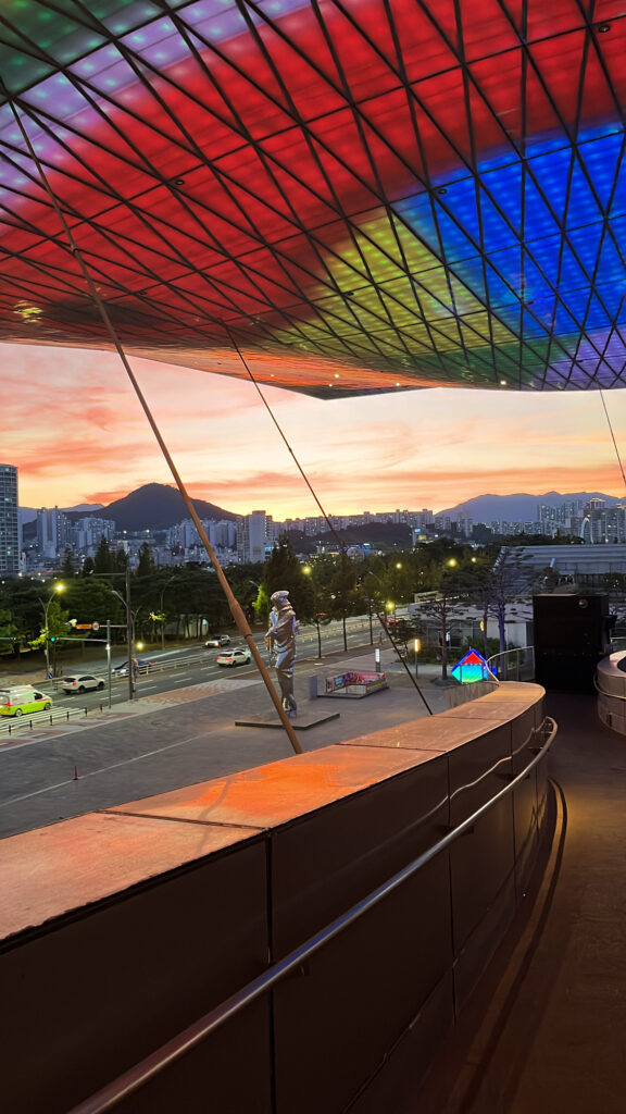 Vibrant rainbow LED lighting illuminating the Busan Cinema Center roof at night