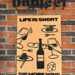 Danicci red brick exterior with modern wine and food poster