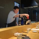 Japanese chef cooking behind the counter bar at Murasaki Busan