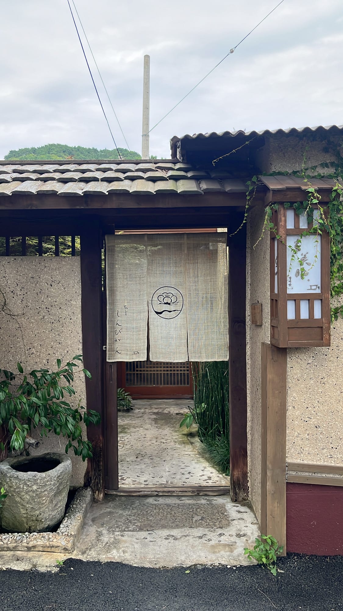 Japanese-style entrance gate with noren fabric at Simmian Busan