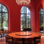 Grand private dining room featuring a round wooden table and crystal chandelier at Village de Ananti Lou Busan