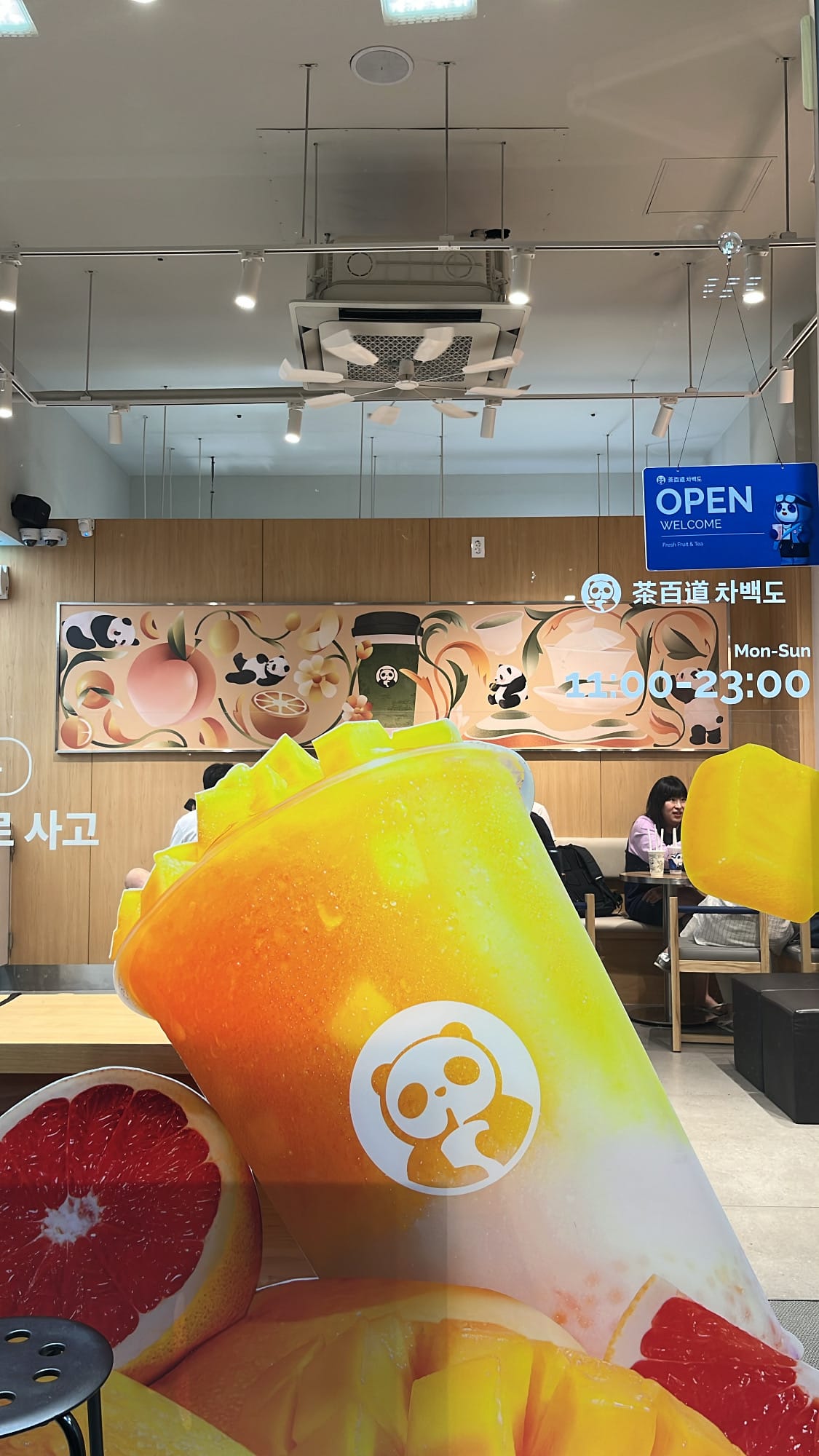 Brightly lit modern storefront of ChaPanda Busan Centum with outdoor patio seating at night