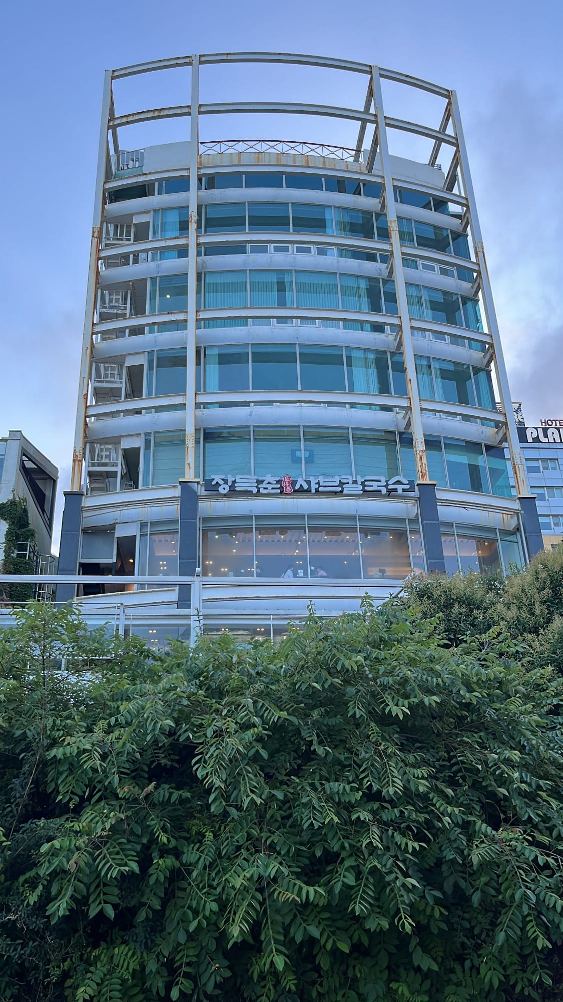 Curved glass exterior building of Jang Deuk Chun Shabu Kalguksu near Songjeong Beach