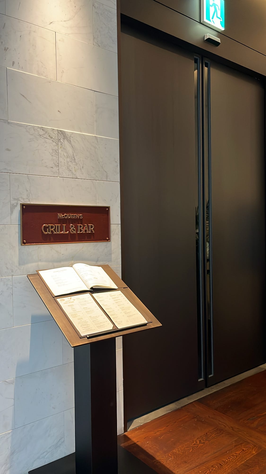 Entrance doorway and menu display on the 10th floor at McQueen's Grill and Bar