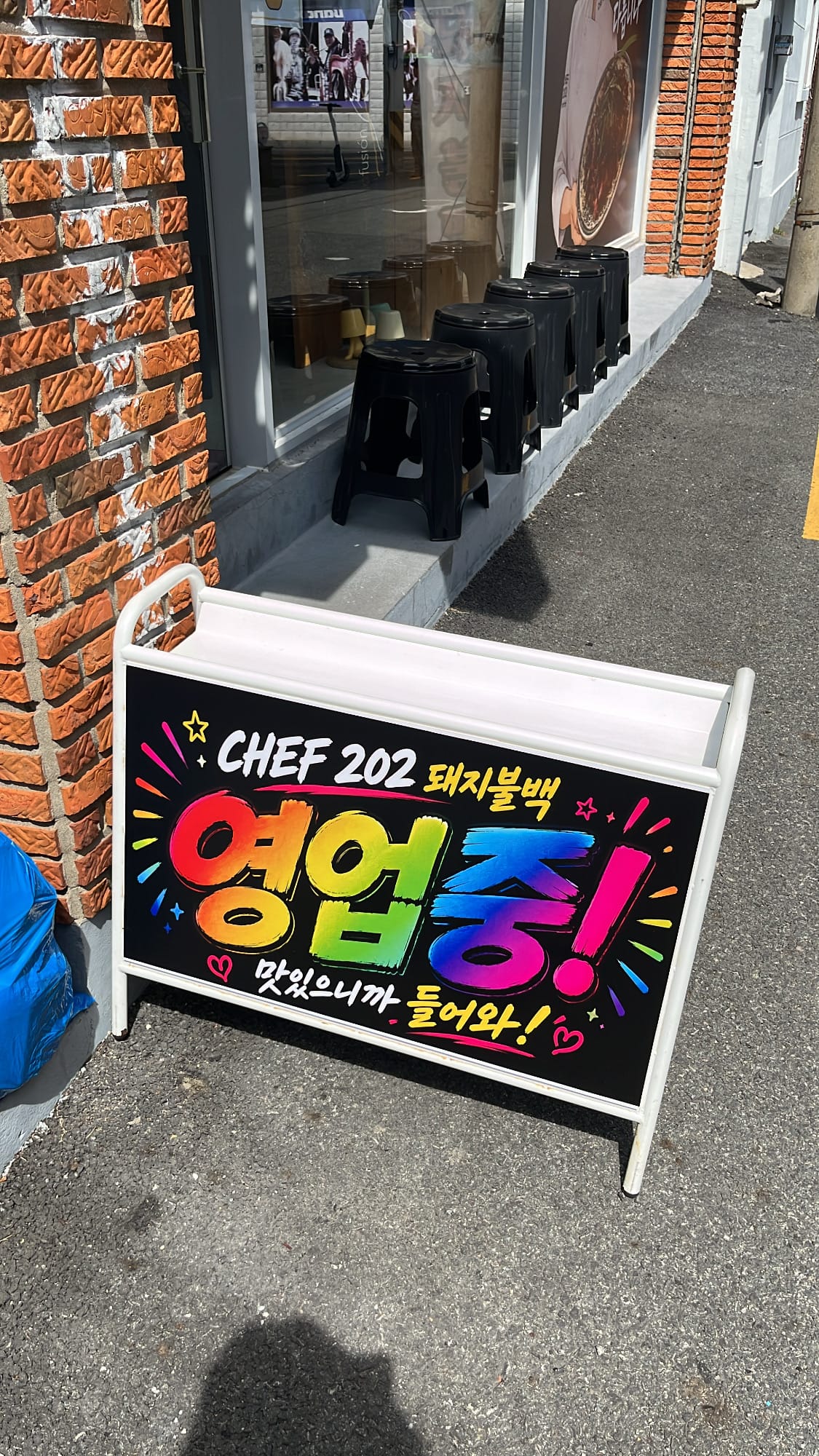 Colorful open sign in front of Chef202 Busan restaurant