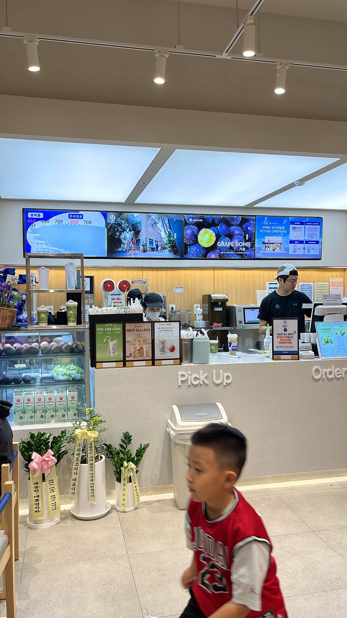 Bright ordering counter and pick-up area with digital menu boards at ChaPanda Busan Centum