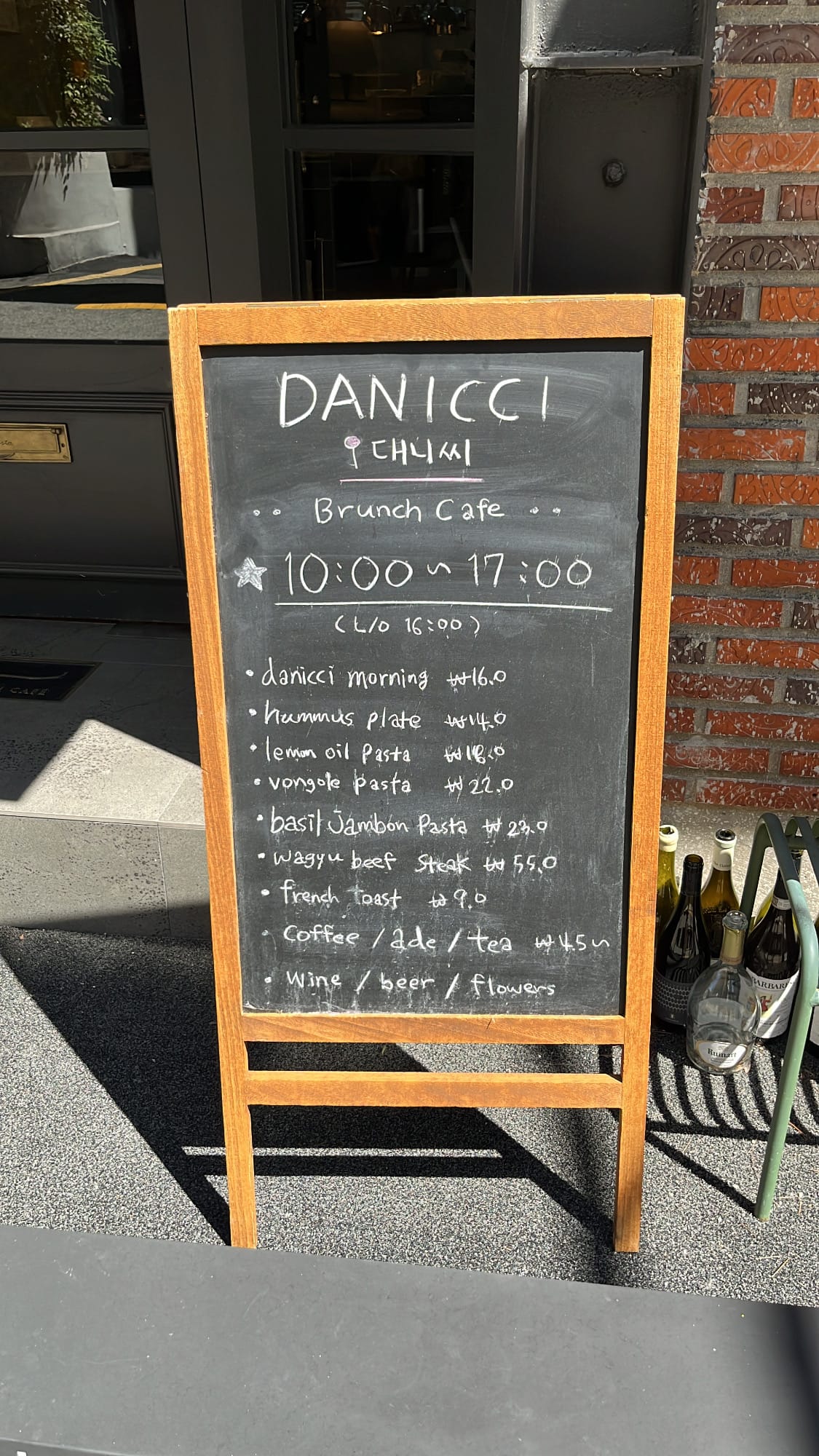 Danicci wooden chalkboard stand listing daily brunch and pasta menu