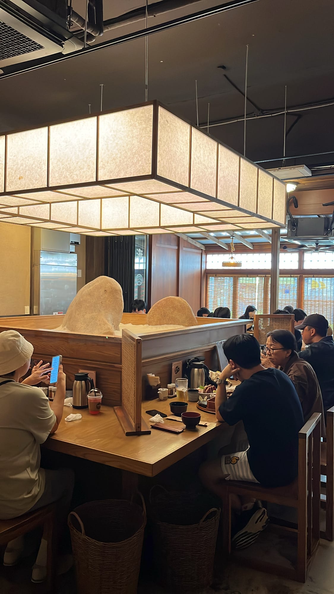 ヘモク・ヘウンデ店内の伝統的なランタンの灯りと木製のブース席