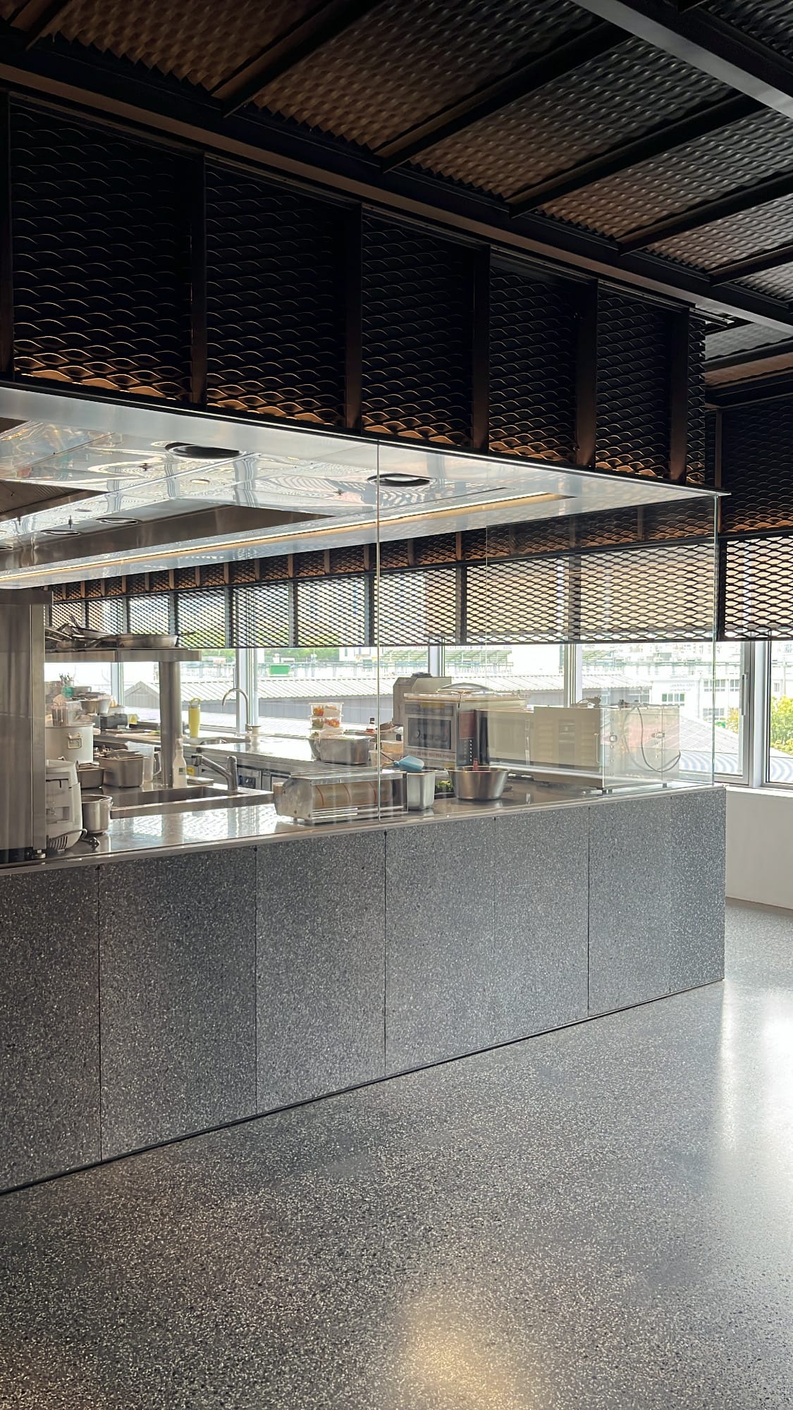 Granite service counter and ceiling mesh design at Michael's Urban Farm Table