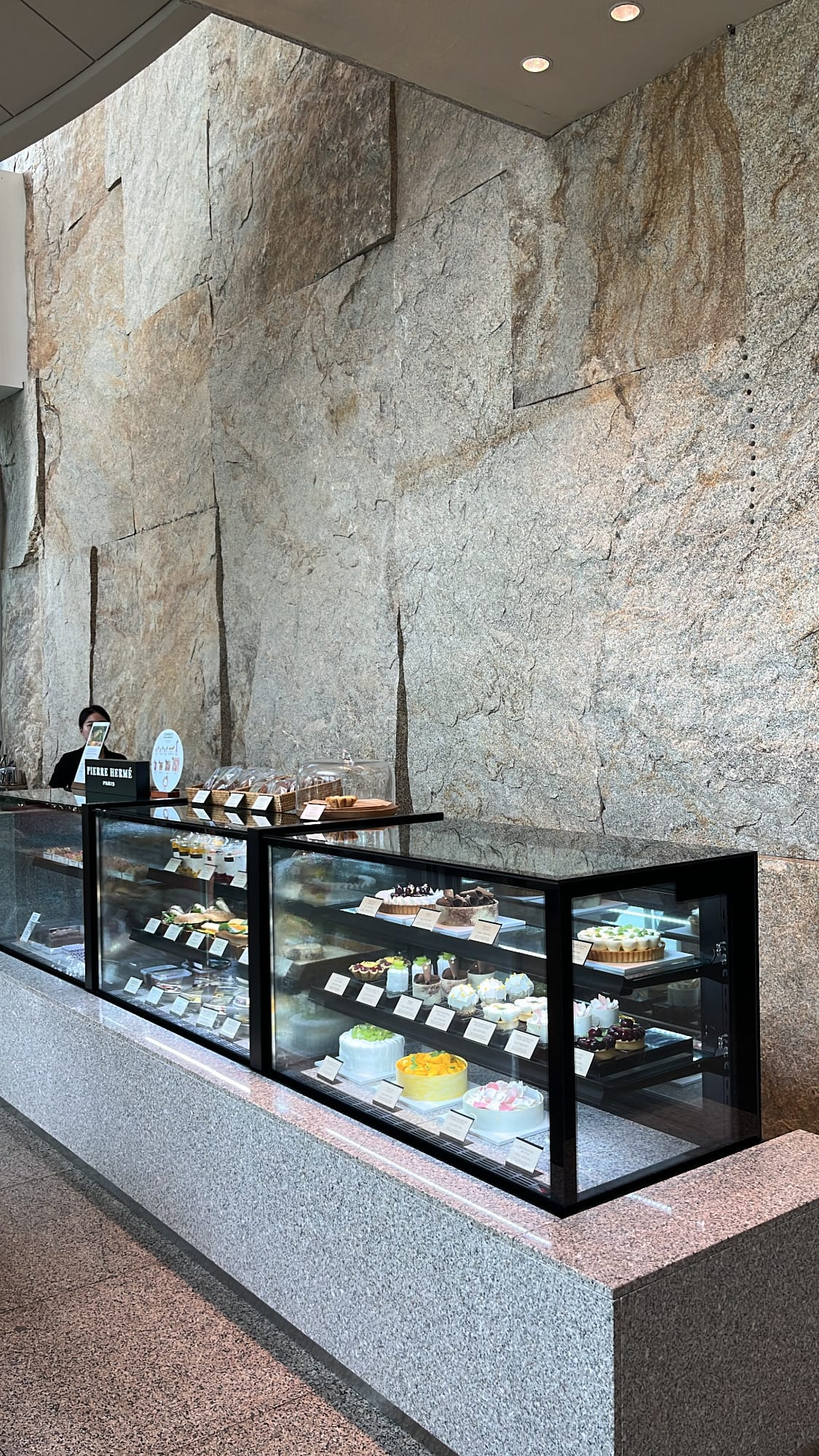 ผนังหินแกรนิตธรรมชาติและตู้แสดงเค้กที่ Patisserie Park Hyatt Busan