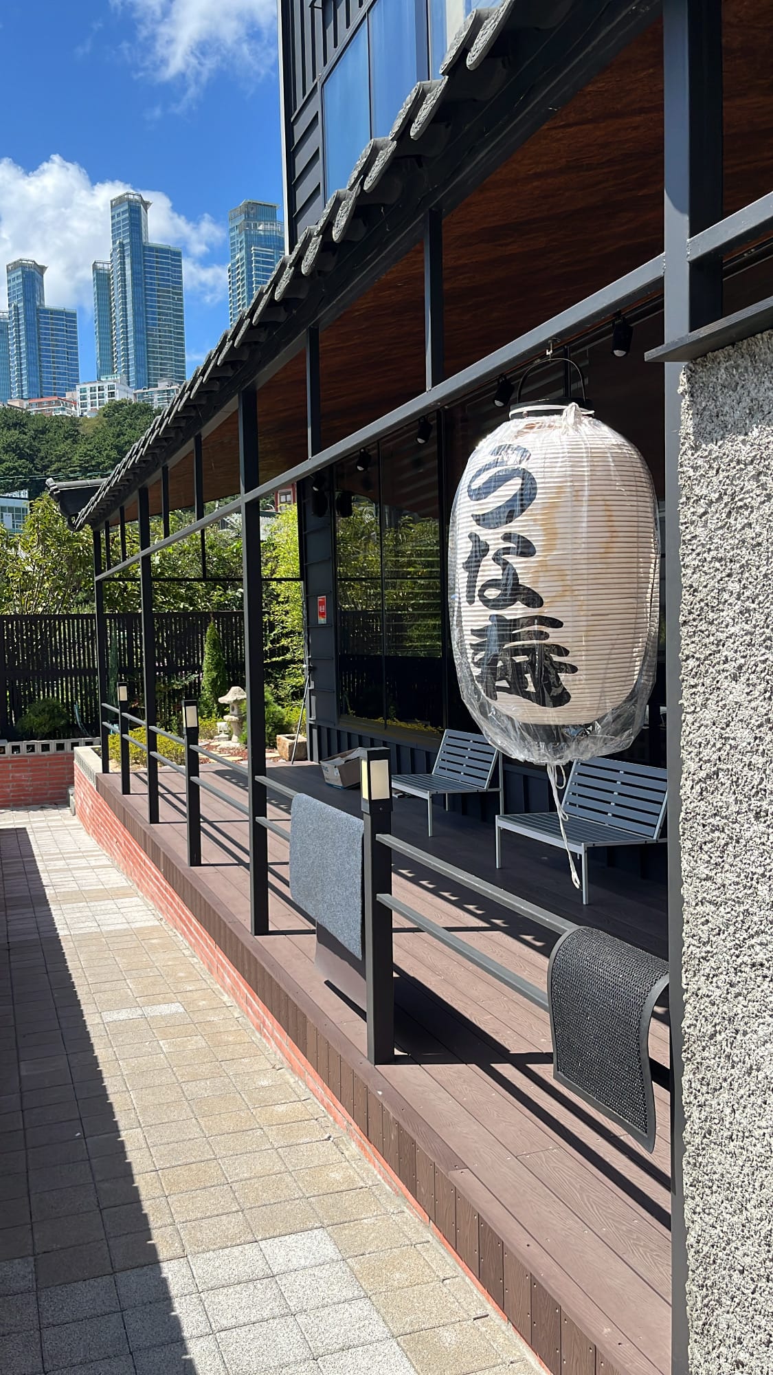 Veranda wooden deck and waiting bench along the outdoor walkway of Unaju Busan