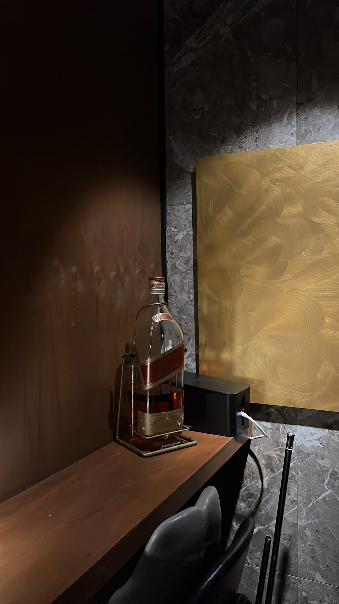 Johnnie Walker Red Label cradle bottle on wooden bar counter