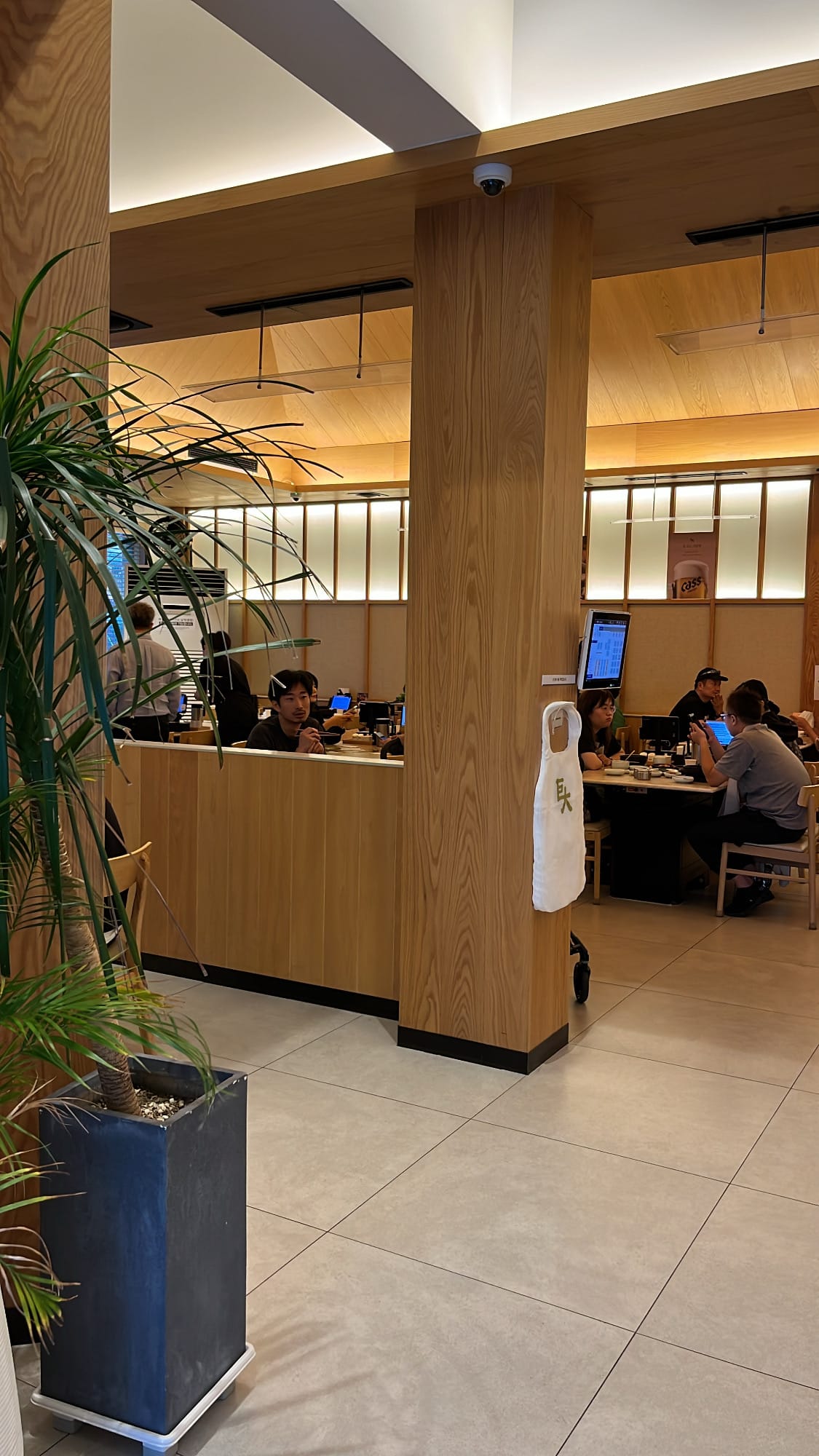 Spacious remodeled interior dining room with light oak wooden accents at Geodae Dwaeji Gukbap Busan