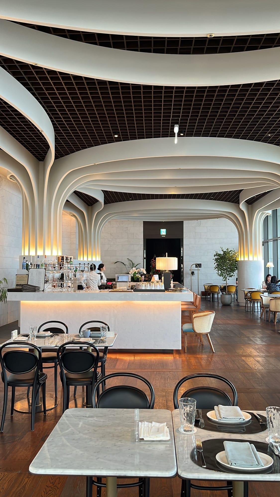 Generously spaced dining tables ensuring private conversation at McQueen's Grill and Bar