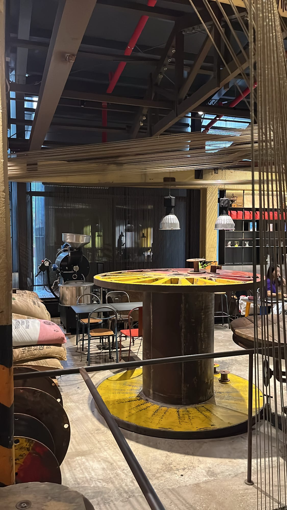Giant industrial cable spools repurposed as coffee tables at Terarosa