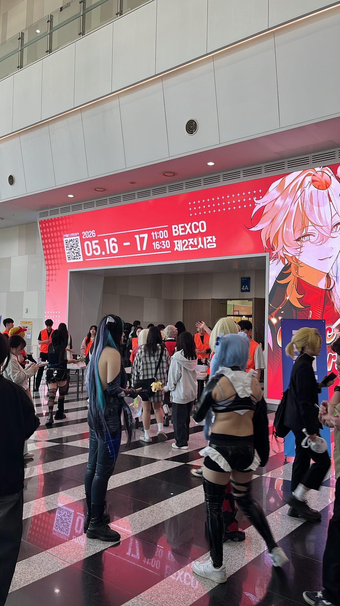 Busan Comic World entrance and costumed attendees at BEXCO