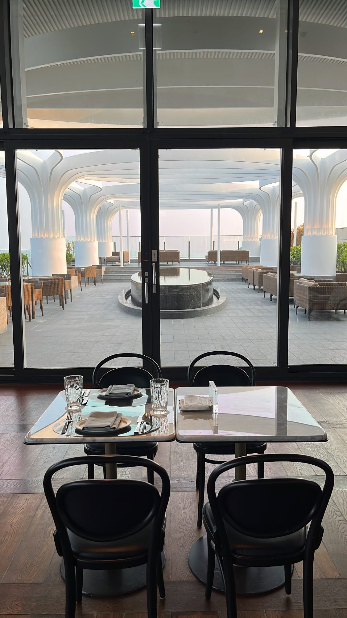 Open-air outdoor dining terrace overlooking the sea at McQueen's Grill and Bar