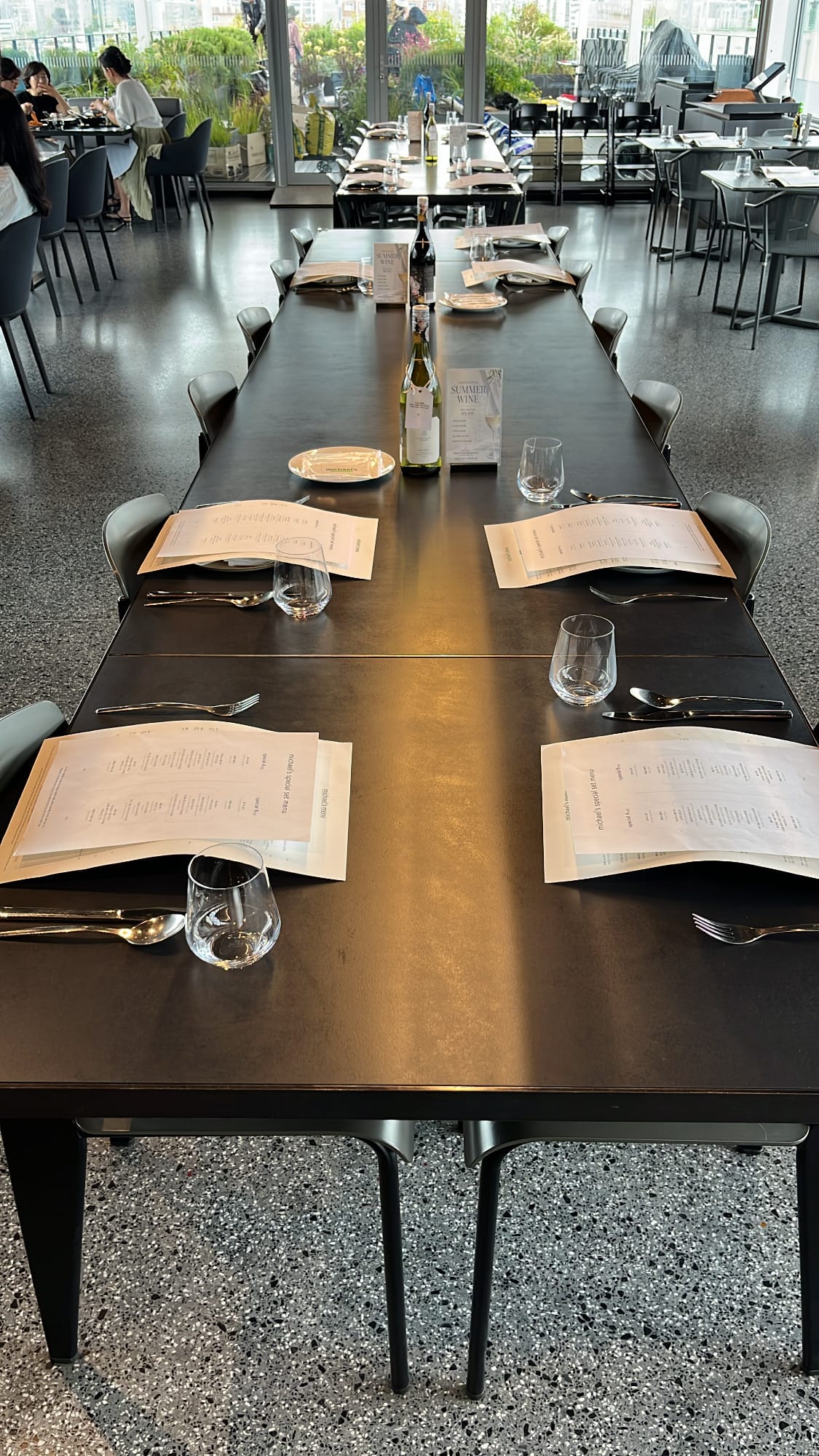 Set long dining table for group gatherings at Michael's Urban Farm Table
