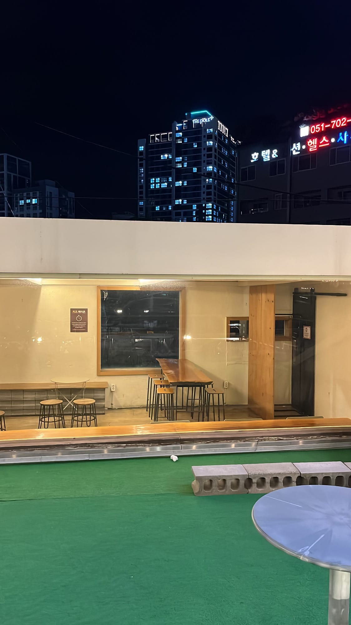 Rooftop terrace seating area at Songjeong Hot Dog Busan